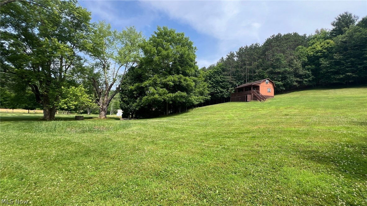5017 Jade Road Northwest Carrollton, OH 44615 - Photo 1 of 22 Welcome to 8.84 acres of land with a rustic cabin, shed, spring, and about 5 acres of woods.
