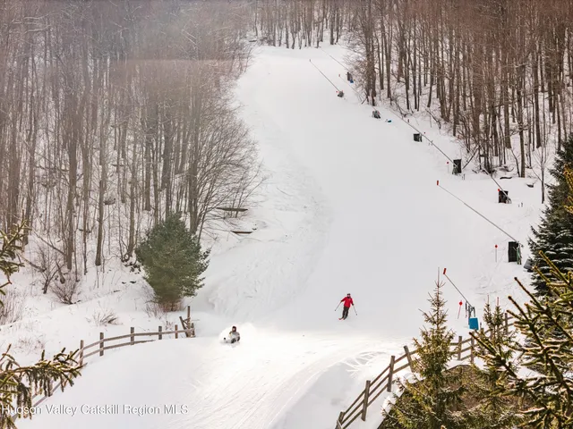 a living room with furniture a flat screen tv and a window