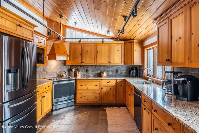 a kitchen with granite countertop a sink and cabinets