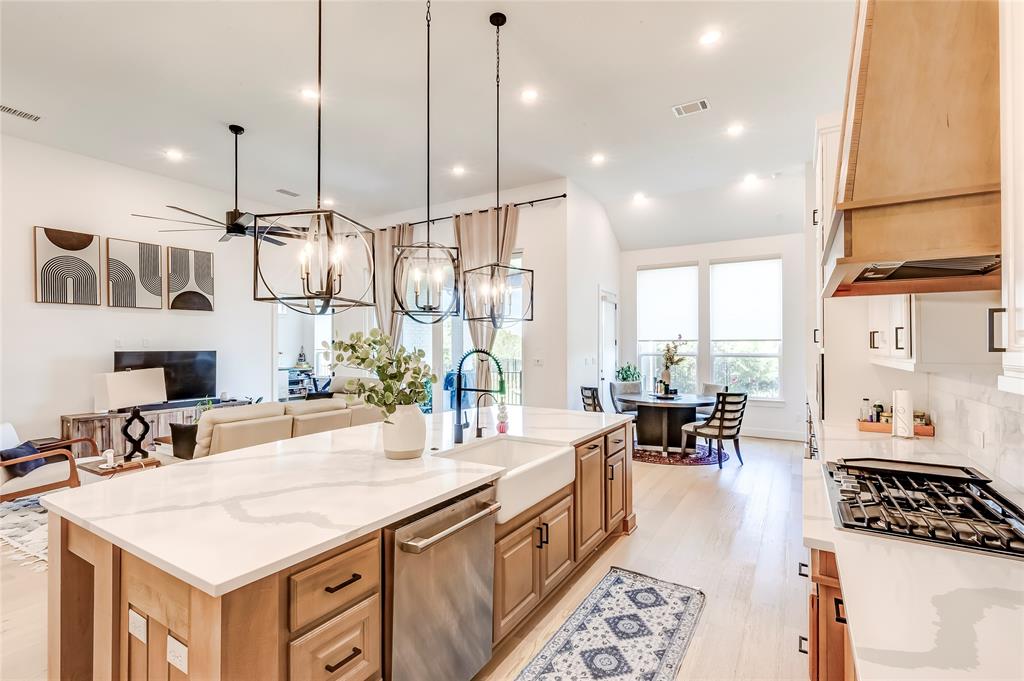126 LITTLE Strm Cove Austin, TX 78737 - Photo 12 of 40 An open-concept living space with a gourmet kitchen island and ample natural light.
