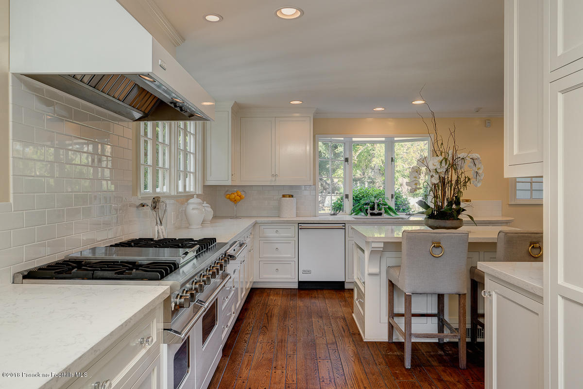 721 Madre Street Pasadena, CA 91107 - Photo 33 of 82 a kitchen with a sink a stove a refrigerator and white cabinets