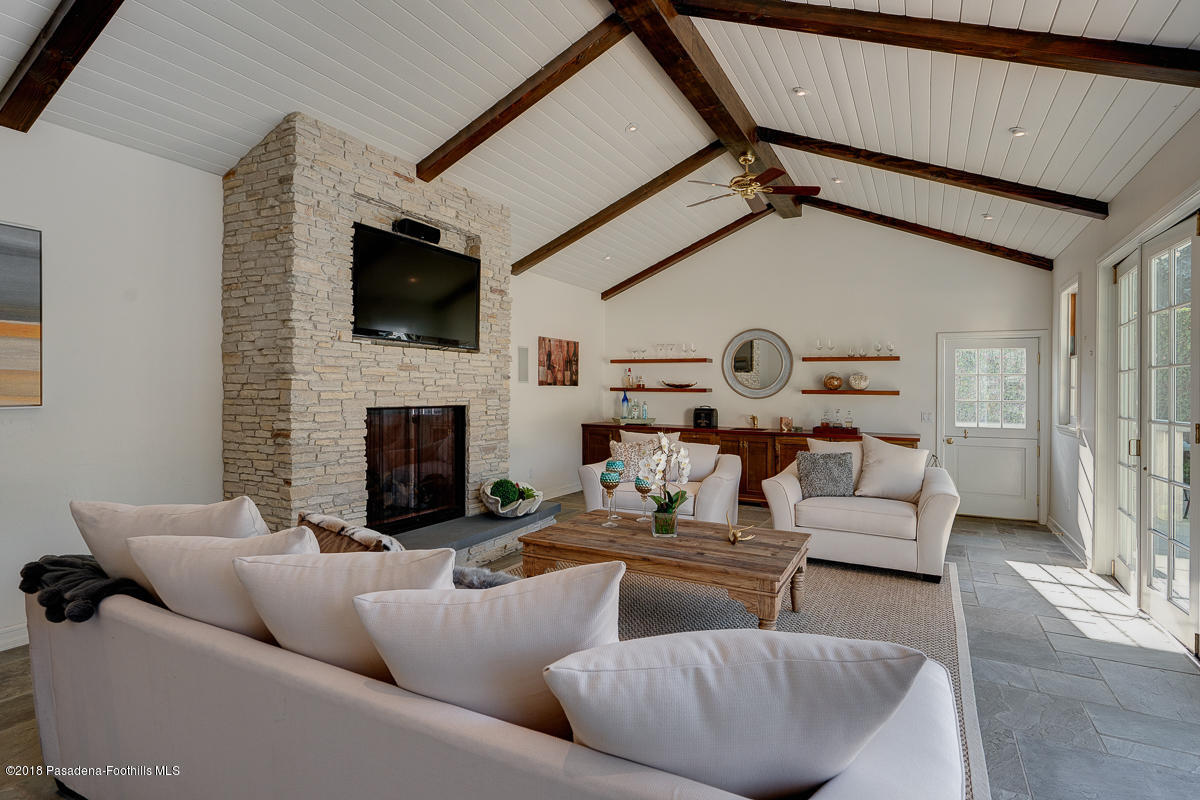 721 Madre Street Pasadena, CA 91107 - Photo 65 of 82 a living room with furniture a flat screen tv and a fireplace