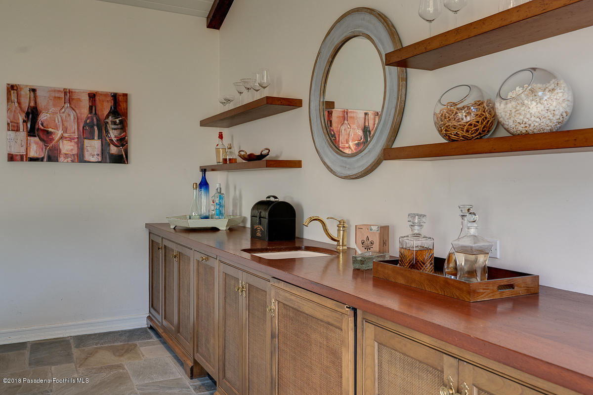 721 Madre Street Pasadena, CA 91107 - Photo 66 of 82 a kitchen with a cabinets and a clock on the wall