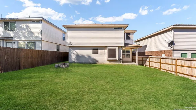 a view of backyard with garden and deck