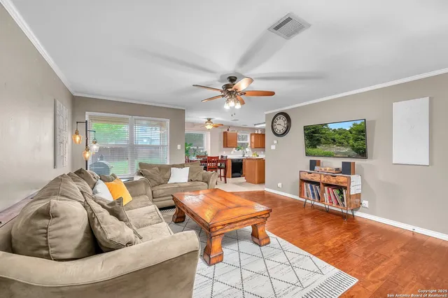 a living room with furniture and wooden floor
