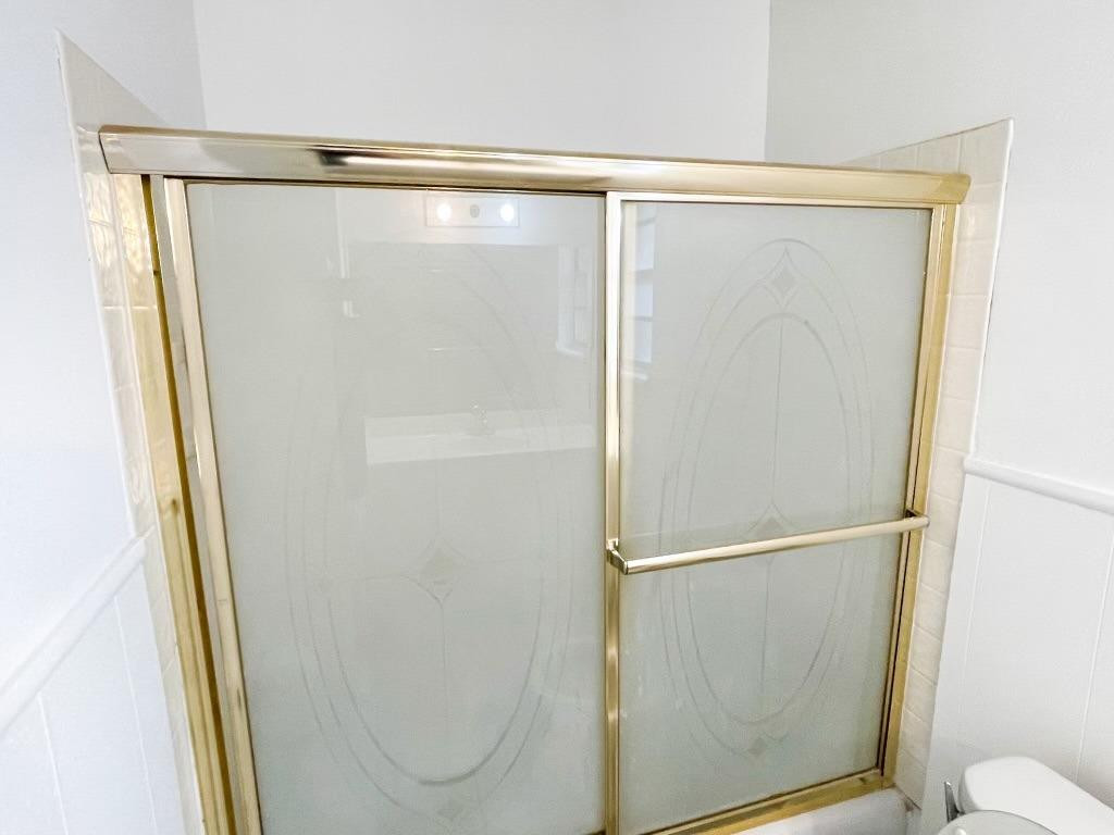 5503 36th Street Lubbock, TX 79407 - Photo 11 of 15 a bathroom with a glass shower door