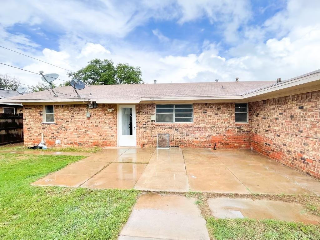 5503 36th Street Lubbock, TX 79407 - Photo 14 of 15 a front view of a house with a yard and garage