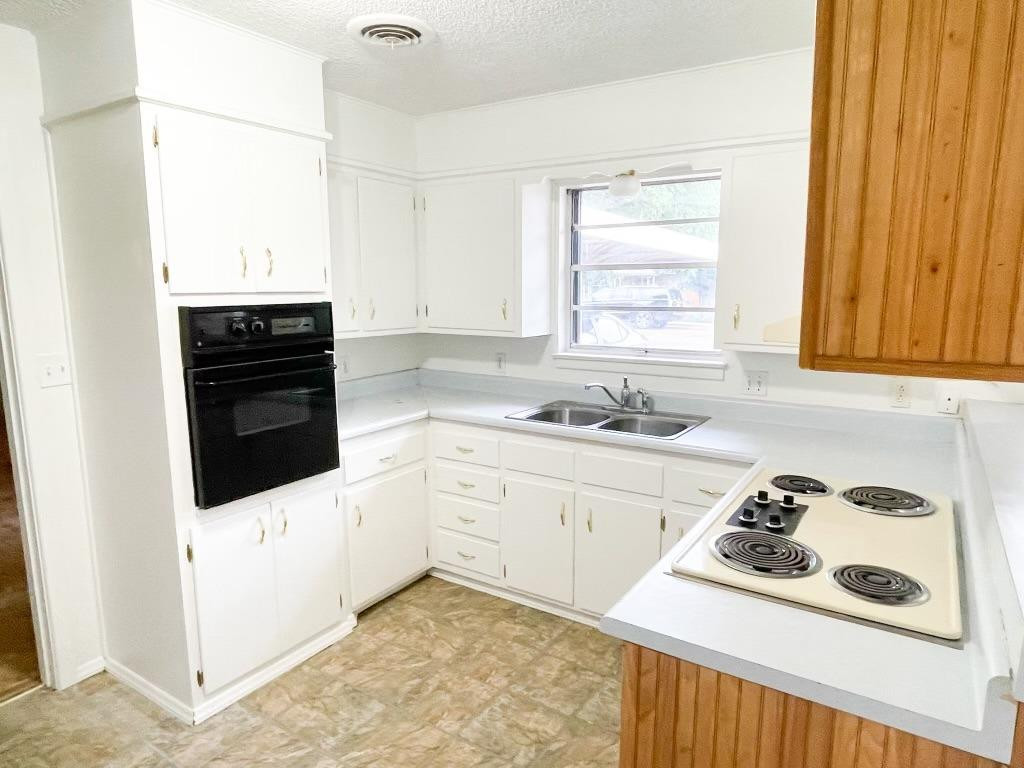 5503 36th Street Lubbock, TX 79407 - Photo 2 of 15 a kitchen with a sink stove and cabinets