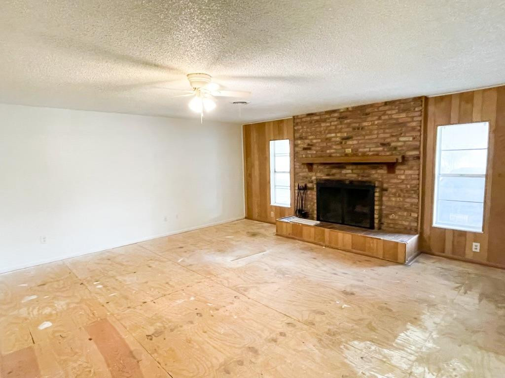 5503 36th Street Lubbock, TX 79407 - Photo 5 of 15 an empty room with a fireplace