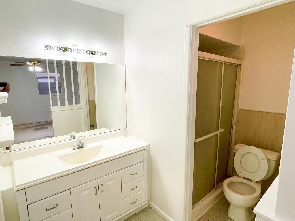 5503 36th Street Lubbock, TX 79407 - Photo 8 of 15 a bathroom with a granite countertop toilet sink and mirror