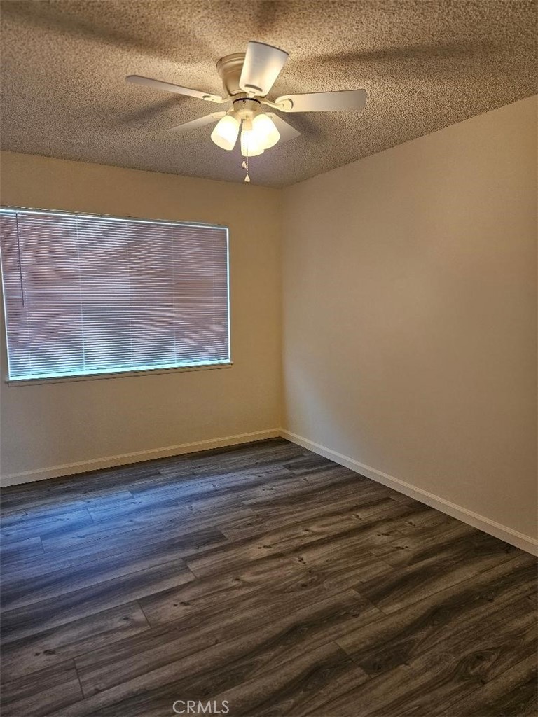 12627 Longleaf Drive La Mirada, CA 90638 - Photo 12 of 19 a view of a room with wooden floor and a ceiling fan