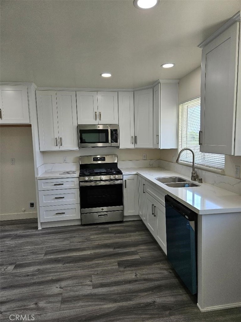 12627 Longleaf Drive La Mirada, CA 90638 - Photo 5 of 19 a kitchen with granite countertop a sink cabinets and stainless steel appliances