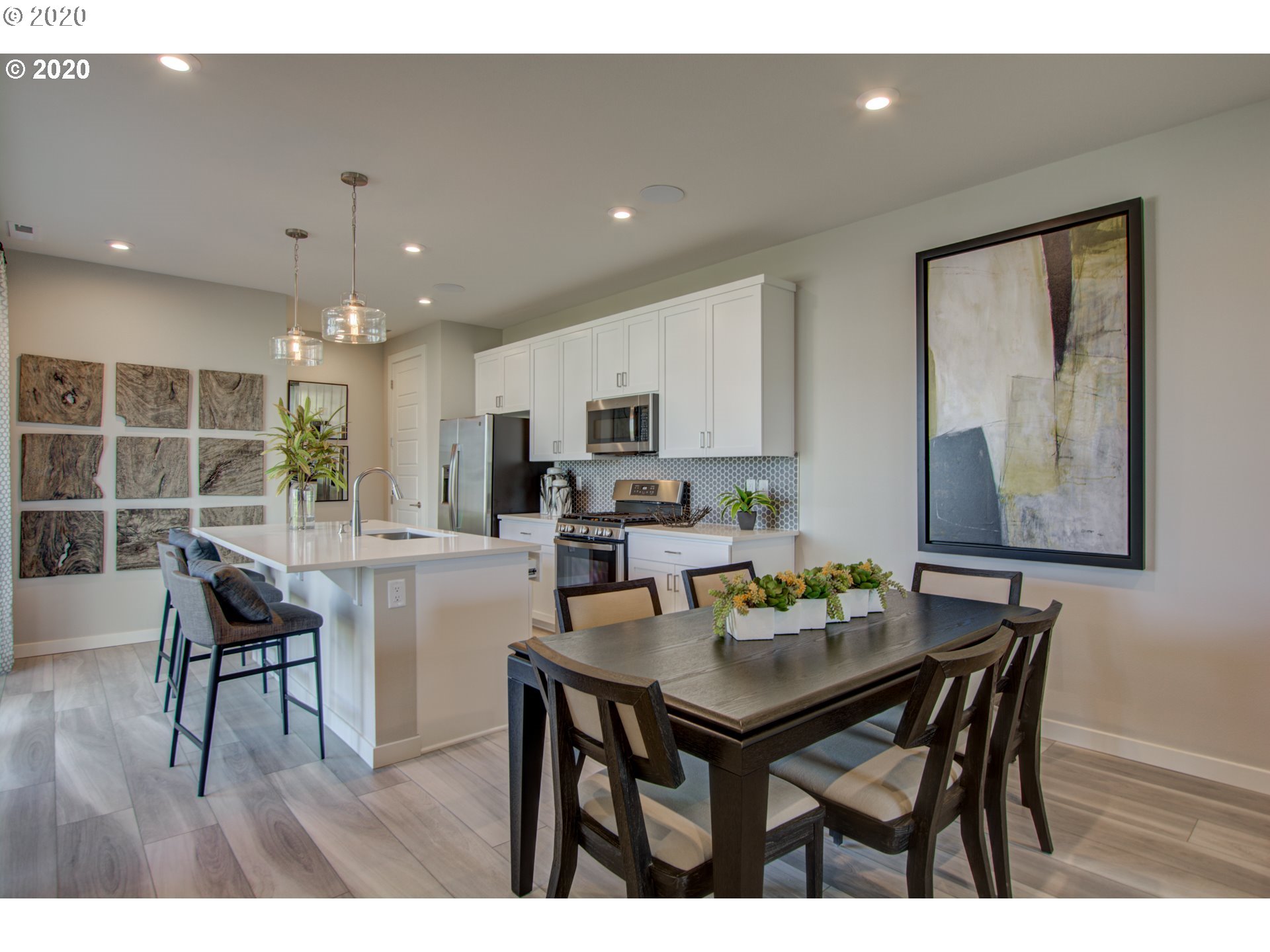 8247 Southeast Kinnaman Road Hillsboro, OR 97123 - Photo 23 of 26 a kitchen with a dining table chairs and microwave