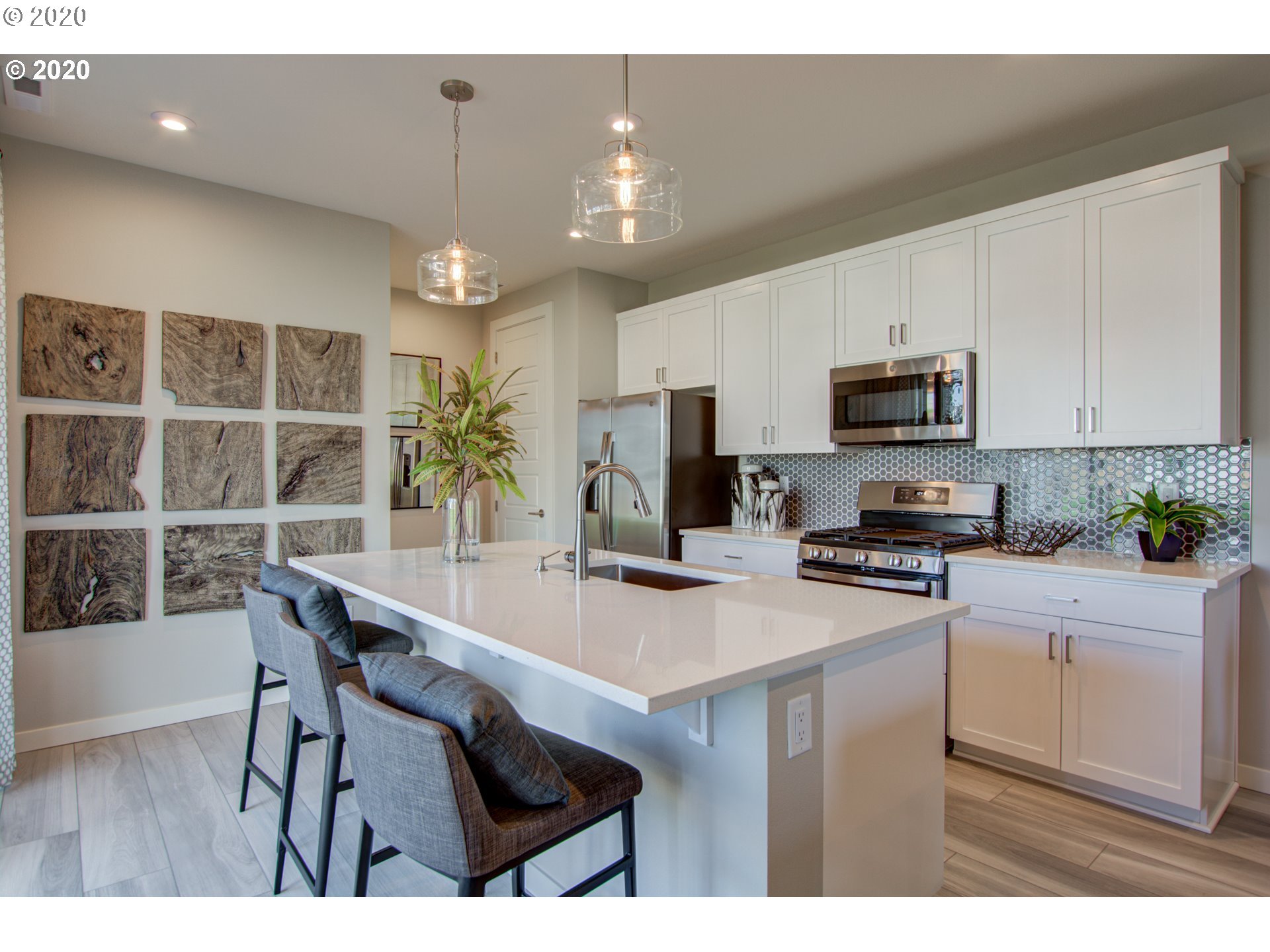 8247 Southeast Kinnaman Road Hillsboro, OR 97123 - Photo 26 of 26 a kitchen with kitchen island granite countertop a stove a sink a microwave a dining table and chairs