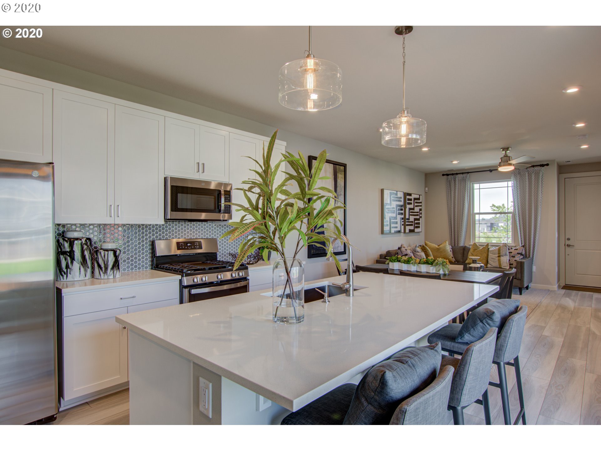 8247 Southeast Kinnaman Road Hillsboro, OR 97123 - Photo 5 of 26 a kitchen with kitchen island a sink table and chairs