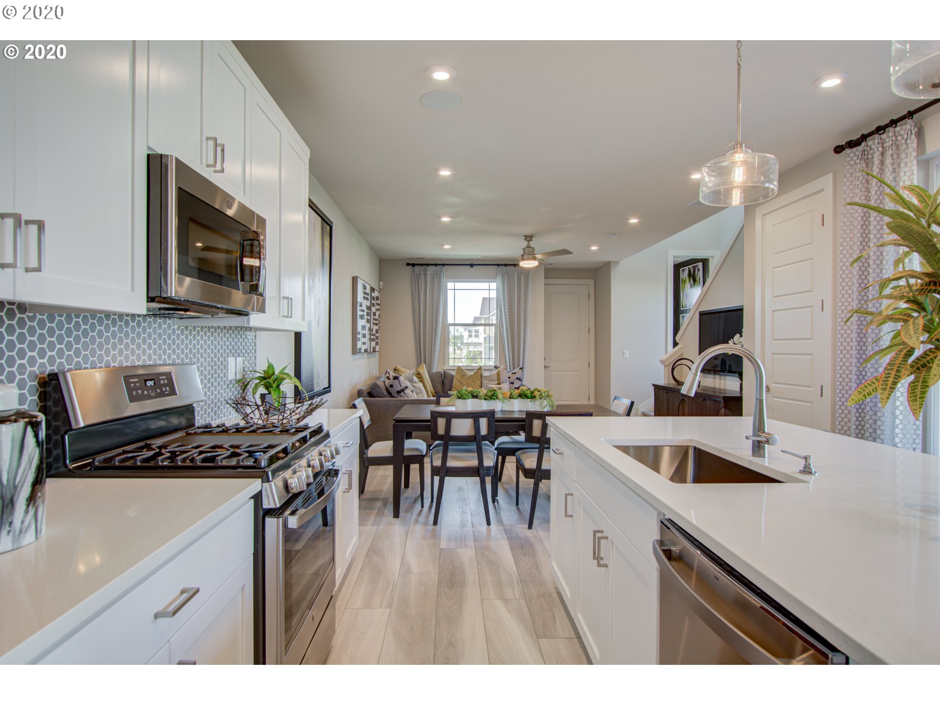 8247 Southeast Kinnaman Road Hillsboro, OR 97123 - Photo 7 of 26 a kitchen with stainless steel appliances a sink stove and cabinets