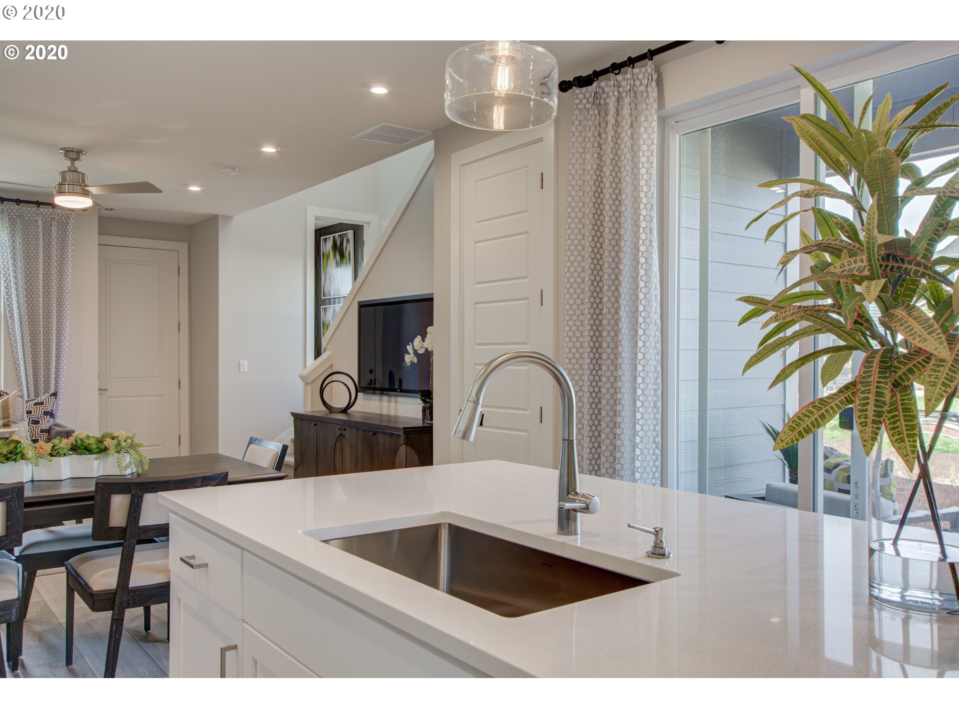 8247 Southeast Kinnaman Road Hillsboro, OR 97123 - Photo 8 of 26 a kitchen with a sink a counter space and a dining room