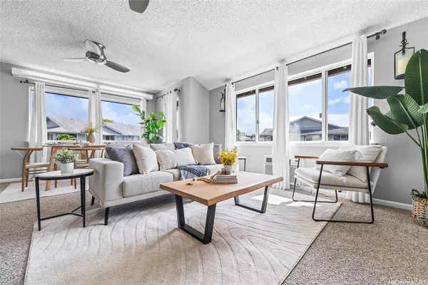 a living room with furniture and a large window