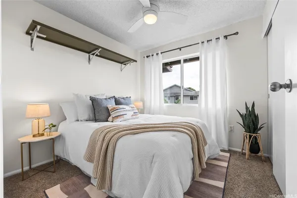 a bedroom with a bed and a window