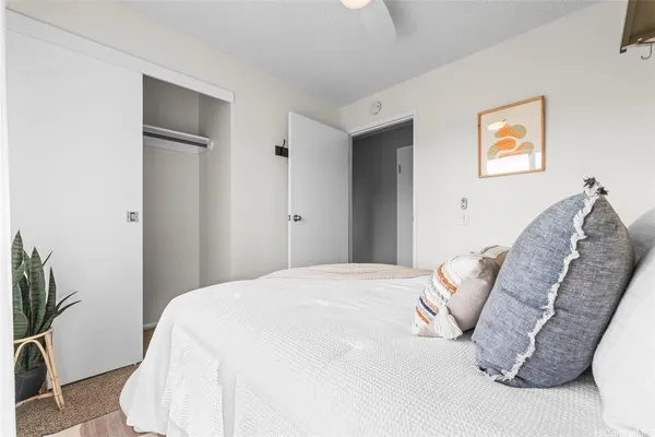 a bedroom with a bed and a potted plant