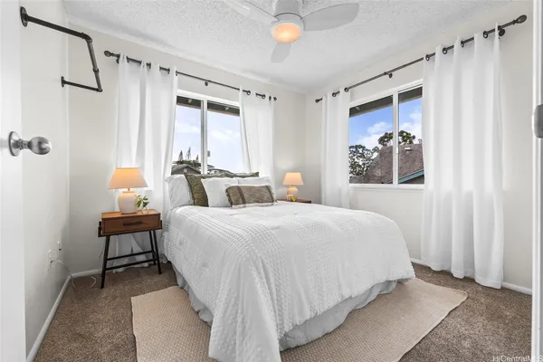 a bedroom with a bed and a painting on the wall