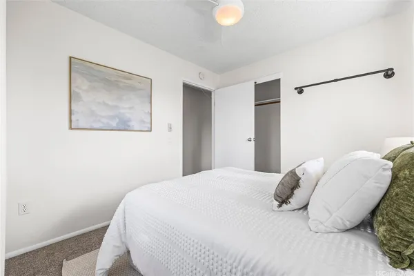 a bedroom with a bed and a painting on the wall