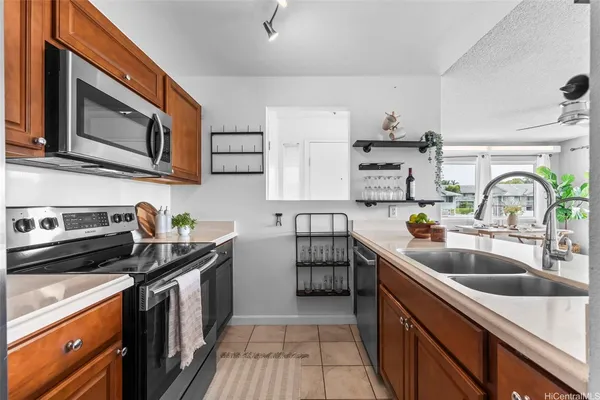 a kitchen with stainless steel appliances granite countertop a sink stove and cabinets
