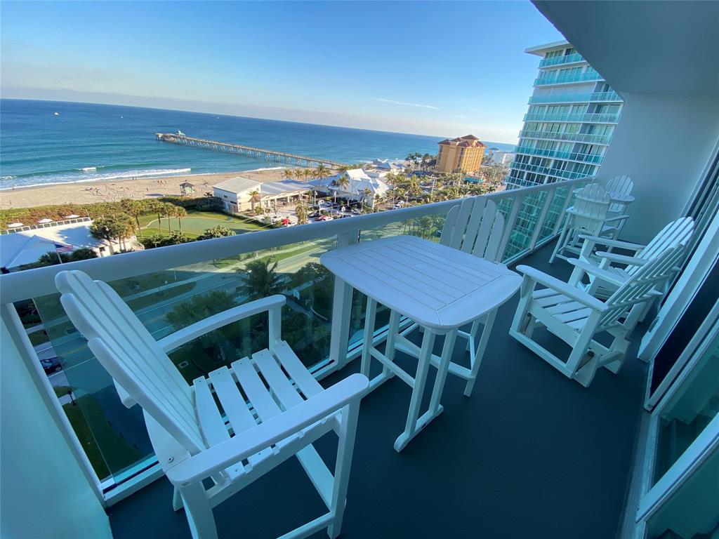 a view of a balcony with table and chairs