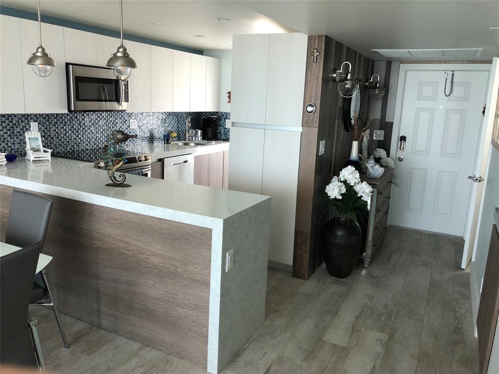 333 Northeast 21st Avenue, Unit 1216 Deerfield Beach, FL 33441 - Photo 11 of 19 a kitchen with stainless steel appliances a refrigerator sink and cabinets