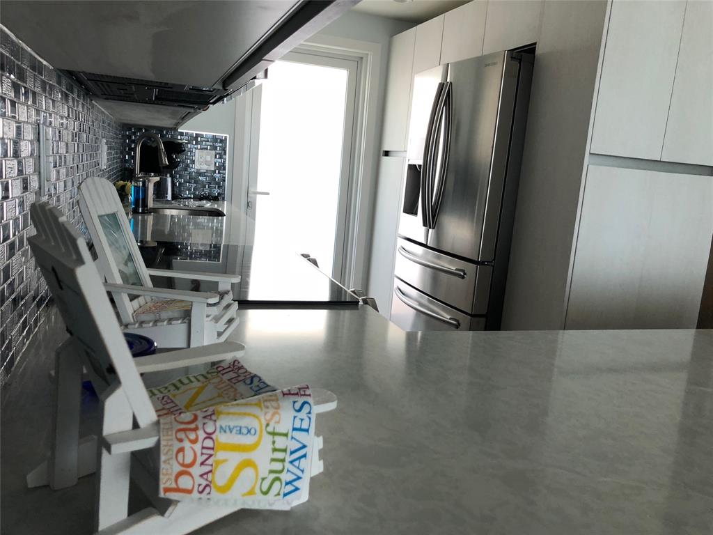 333 Northeast 21st Avenue, Unit 1216 Deerfield Beach, FL 33441 - Photo 15 of 19 a kitchen with stainless steel appliances granite countertop a refrigerator and a stove