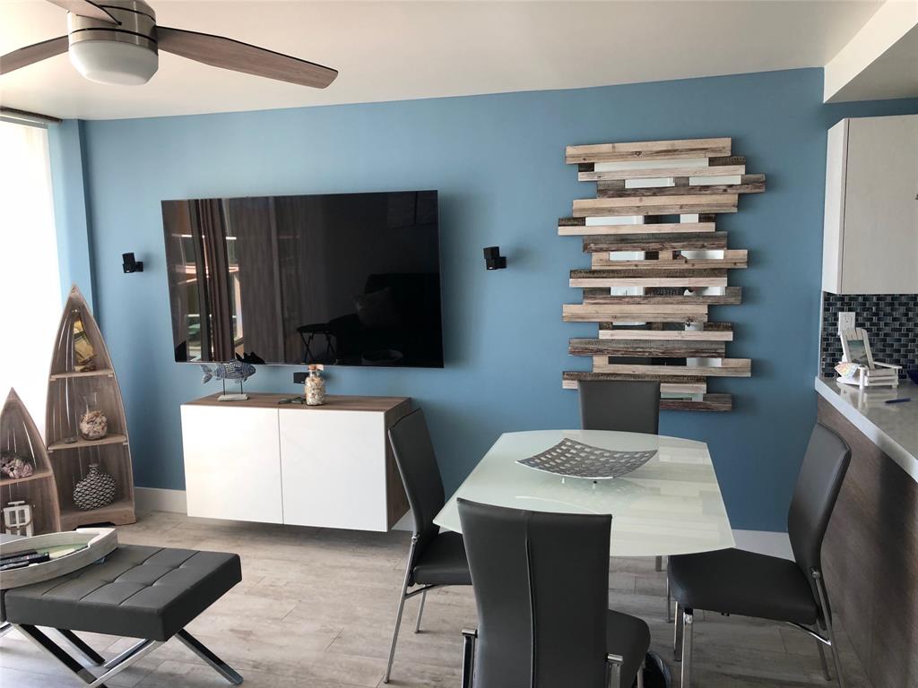 333 Northeast 21st Avenue, Unit 1216 Deerfield Beach, FL 33441 - Photo 17 of 19 a living room with furniture and a flat screen tv