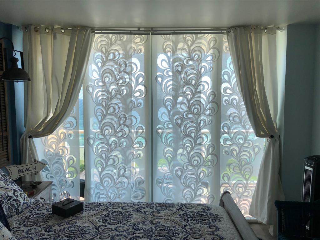 333 Northeast 21st Avenue, Unit 1216 Deerfield Beach, FL 33441 - Photo 18 of 19 a room with a large window and a potted plant