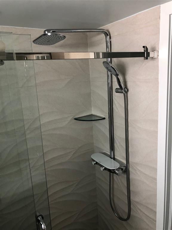 333 Northeast 21st Avenue, Unit 1216 Deerfield Beach, FL 33441 - Photo 8 of 19 a bathroom with a shower