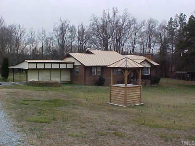 5312 Boston Road Roxboro, NC 27574 - Photo 1 of 1 a front view of a house with a yard