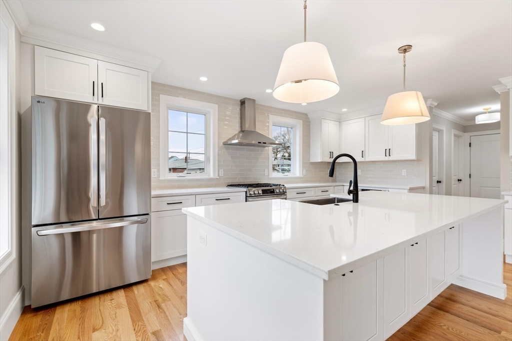 88 Hillcrest Road Waltham, MA 02451 - Photo 16 of 39 a kitchen with stainless steel appliances granite countertop a refrigerator a sink and a stove