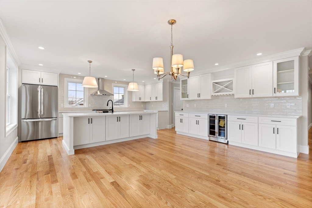 88 Hillcrest Road Waltham, MA 02451 - Photo 20 of 39 a large kitchen with stainless steel appliances kitchen island a large counter tops and a wooden floors