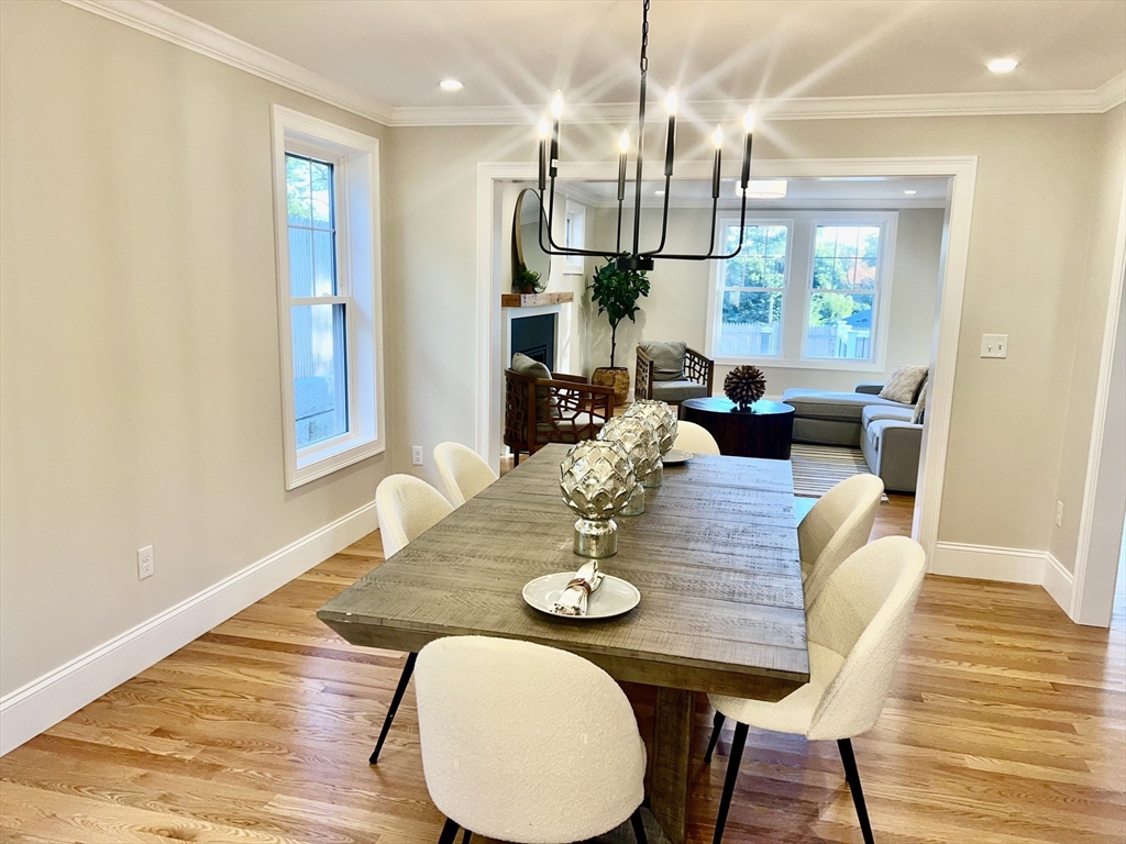88 Hillcrest Road Waltham, MA 02451 - Photo 8 of 39 a view of a dining room with furniture a chandelier and wooden floor