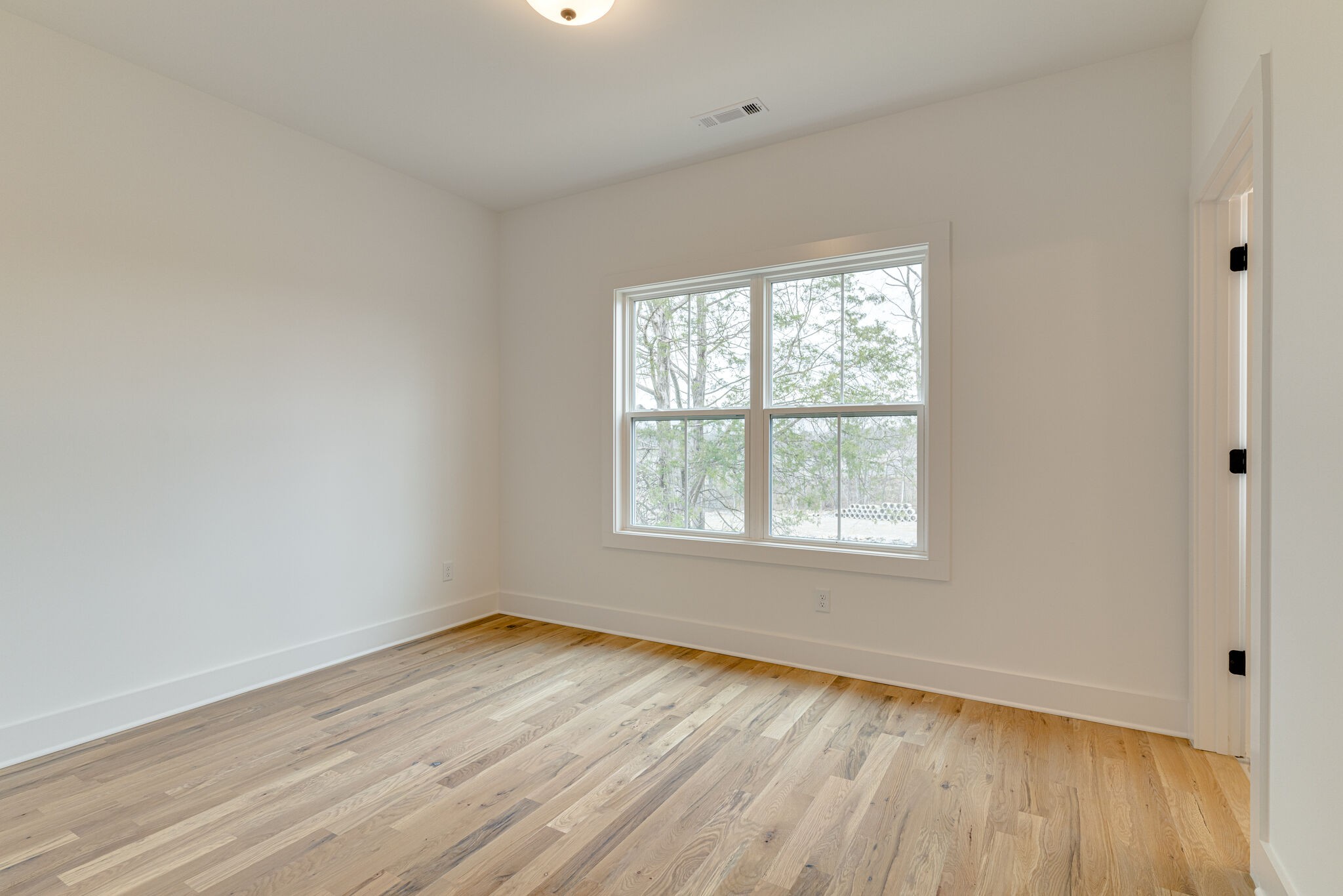 1206 Apache Lane Madison, TN 37115 - Photo 19 of 39 an empty room with wooden floor and windows