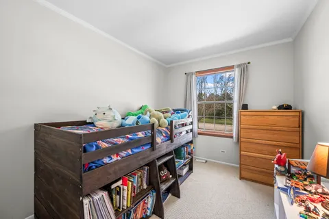 a bedroom with furniture and a window