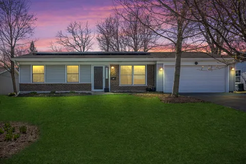 a front view of house with yard and green space