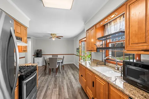 a kitchen with granite countertop lots of counter top space and wooden floor