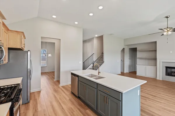 a view of empty room with wooden floor and fireplace