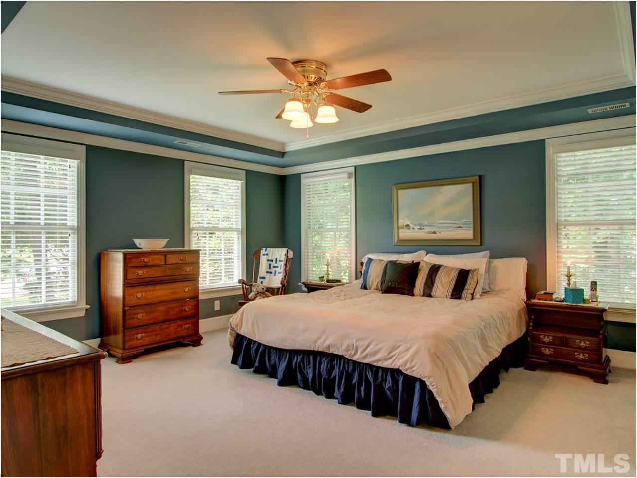 9021 Hemingwood Court Raleigh, NC 27613 - Photo 14 of 25 a bedroom with a bed and a dresser
