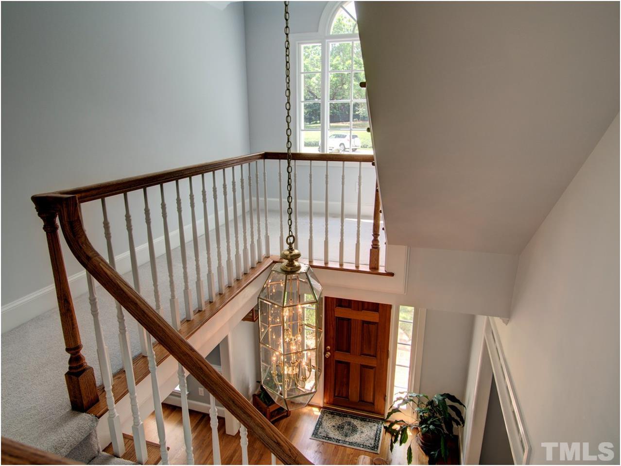 9021 Hemingwood Court Raleigh, NC 27613 - Photo 4 of 25 a view of entryway with wooden floor and stairs