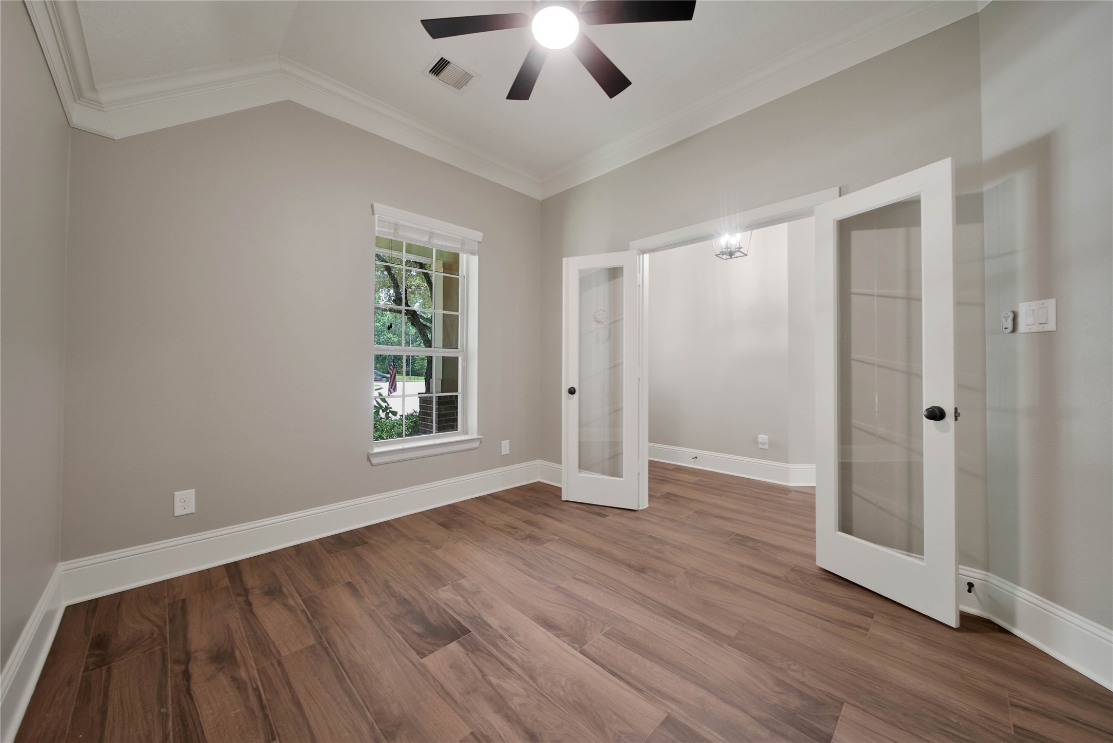 1215 Jake Springs Court Spring, TX 77386 - Photo 4 of 49 The study overlooking your beautiful front yard is a productive work space with glass French doors for privacy and a continuation of the wood-look tile floors and double crown molding.