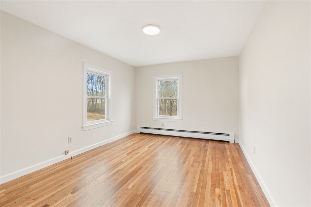 10 Dulgarian Terrace, Unit 10 Chelmsford, MA 01824 - Photo 11 of 18 an empty room with wooden floor and windows