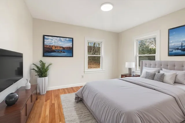 a bedroom with a bed and a flat screen tv