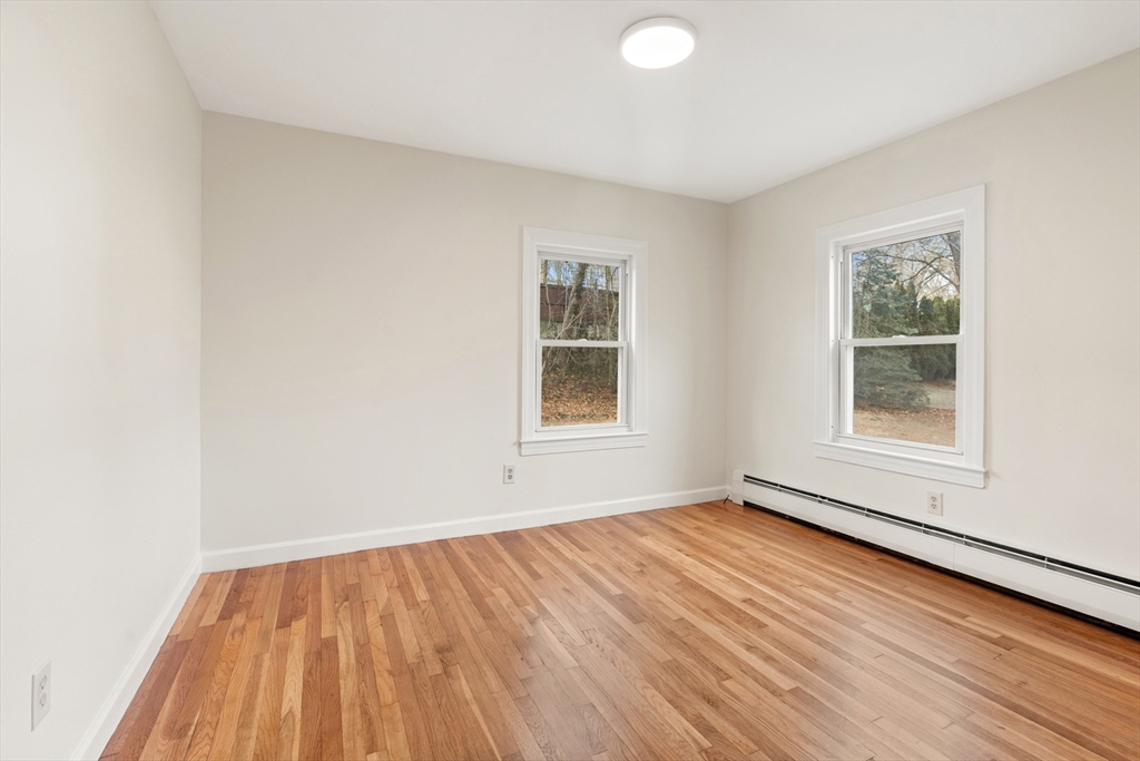 10 Dulgarian Terrace, Unit 10 Chelmsford, MA 01824 - Photo 13 of 18 an empty room with wooden floor and windows