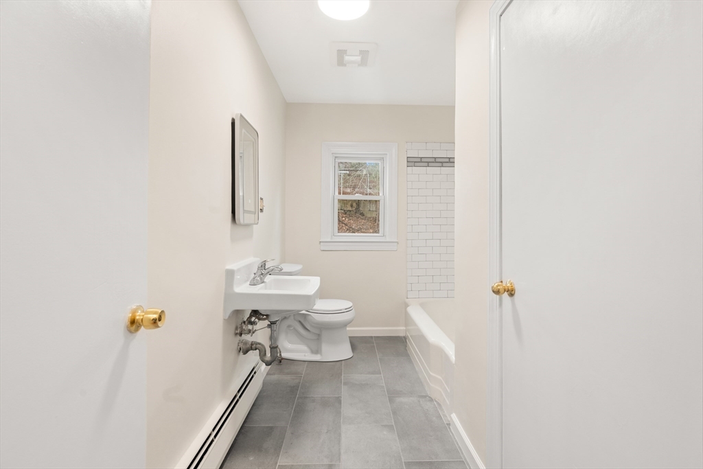 10 Dulgarian Terrace, Unit 10 Chelmsford, MA 01824 - Photo 14 of 18 a bathroom with a sink a toilet and shower
