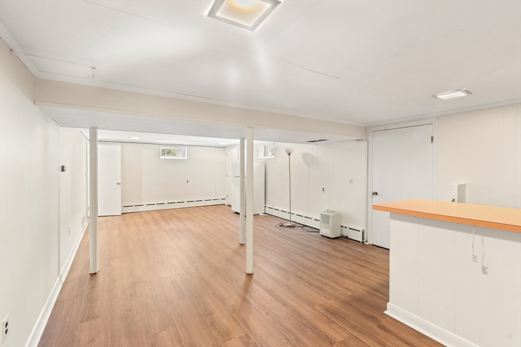 10 Dulgarian Terrace, Unit 10 Chelmsford, MA 01824 - Photo 15 of 18 an empty room with wooden floor and windows